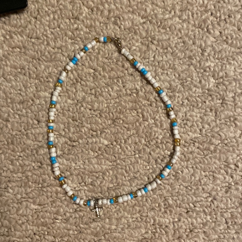 red gold and white necklace with cross charm
